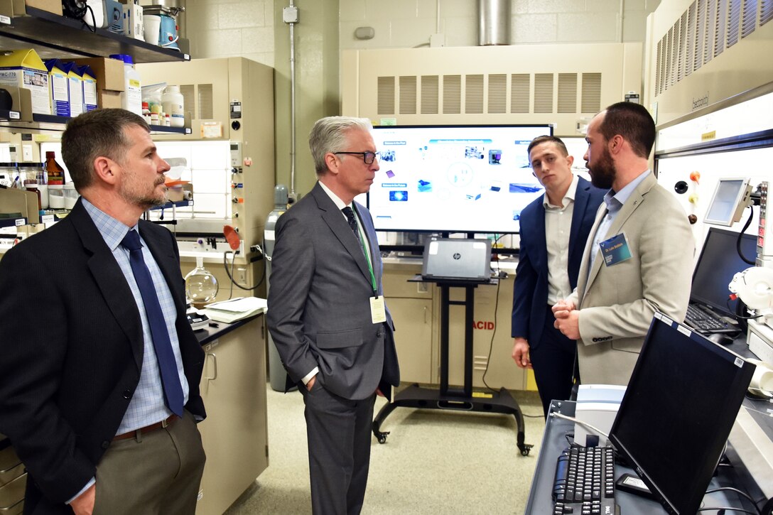 Ohio State University futurist, Dr. David Staley, talks with researchers in the Air Force Research Laboratory chemistry foundry lab. Pictured from left to right are Dr. Russell Kurtz, Dr. David Staley, Dr. Luke Baldwin and Jordan Kaiser. (U.S. Air Force photo/Spencer Deer)