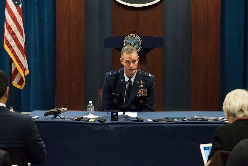 A major general speaks to reporters.