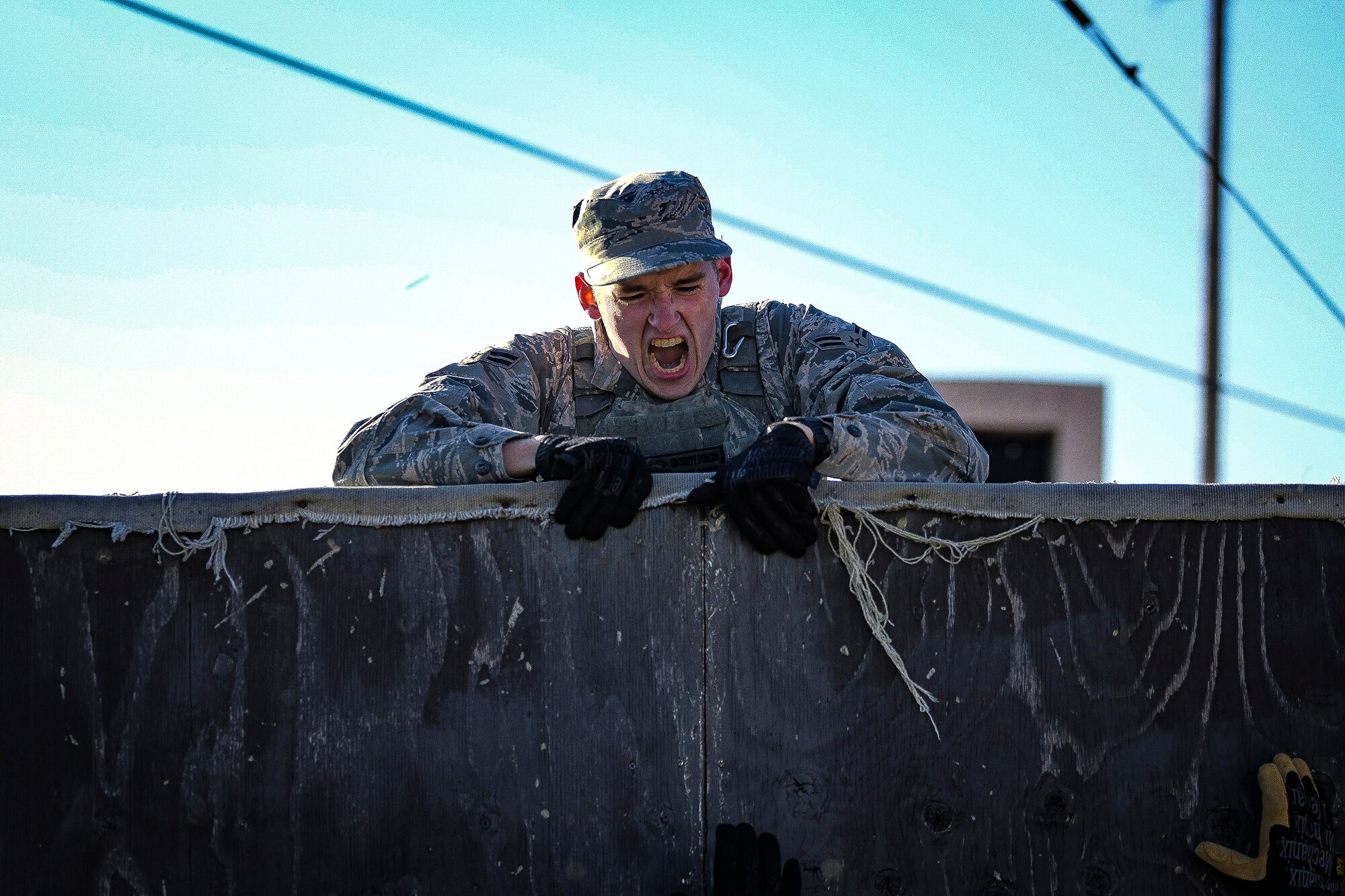 A 51st Security Forces Squadron defender performs a wall climb during a physical training challenge as part of a Combat Readiness Course, Dec. 12, 2019, at Osan Air Base, Republic of Korea. The course challenges Osan’s newest defenders on their readiness and skills to defend the base. (U.S. Air Force photo by Staff Sgt. Greg Nash)