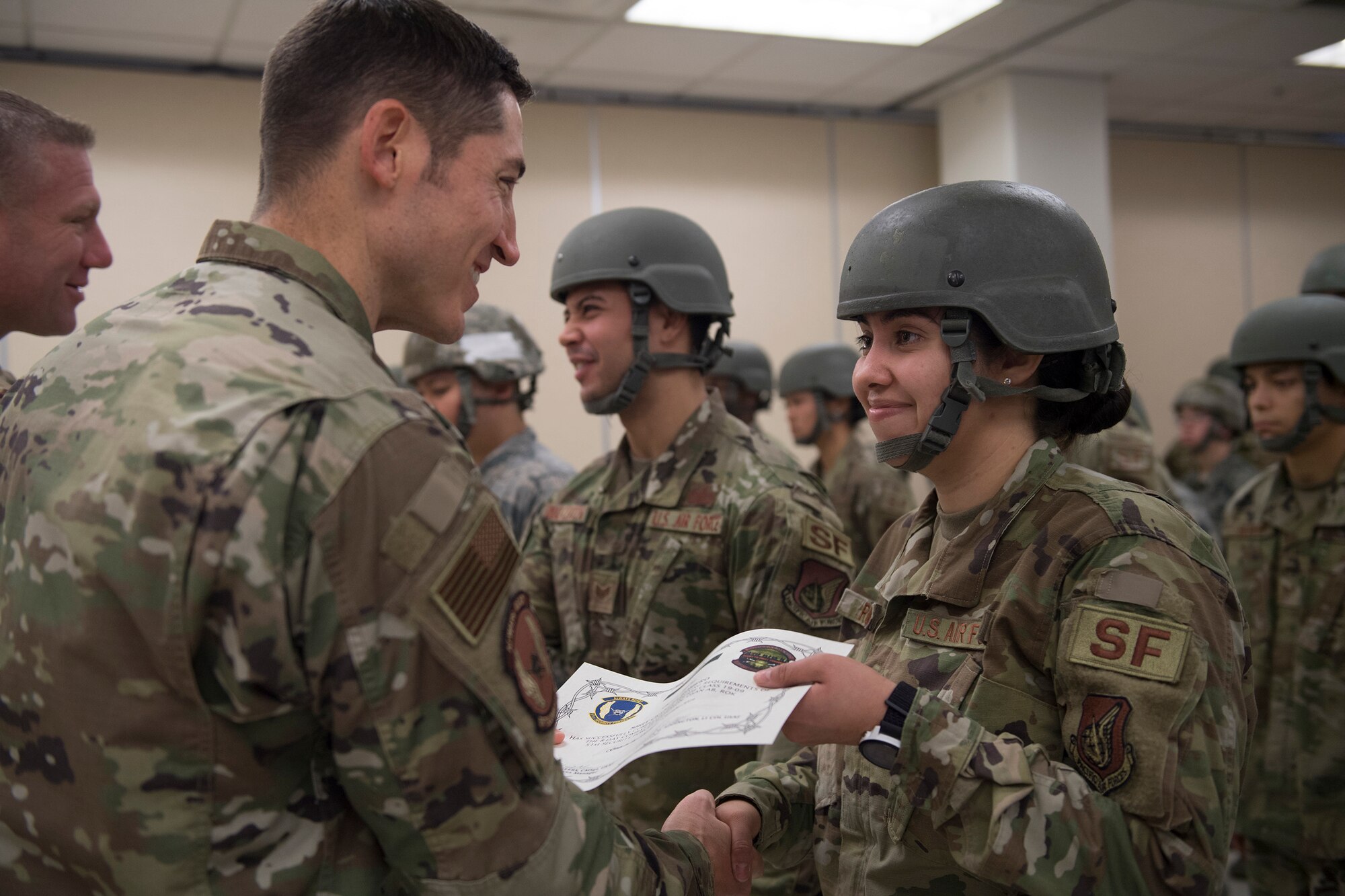 51st Security Forces Squadron defenders accept their certificates during a Combat Readiness Course graduation, Dec. 20, 2019, at Osan Air Base, Republic of Korea. The course challenges Osan’s newest defenders on their readiness and skills to defend the base. (U.S. Air Force photo by Staff Sgt. Greg Nash)