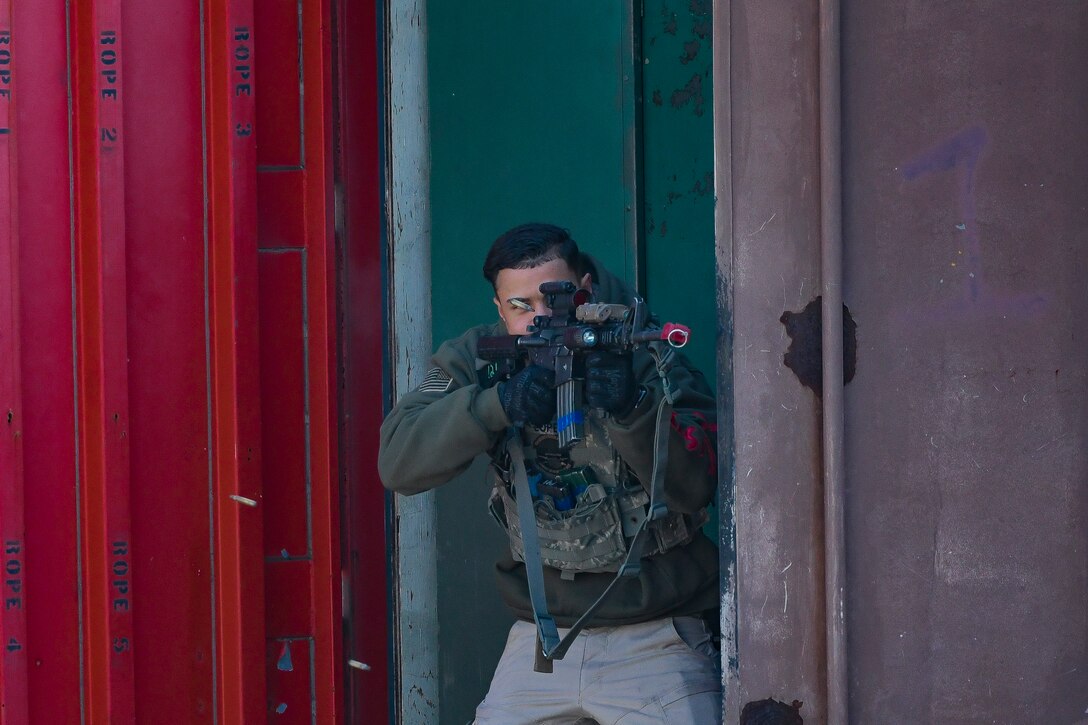 Senior Airman Paul Lopes, 51st Security Forces Squadron Combat Readiness Course instructor, returns simulated fire as he fends off 51st SFS defenders during a CRC, Dec. 19, 2019, at Osan Air Base, Republic of Korea.  The course challenges Osan’s newest defenders on their readiness and skills to defend the base. (U.S. Air Force photo by Staff Sgt. Greg Nash)