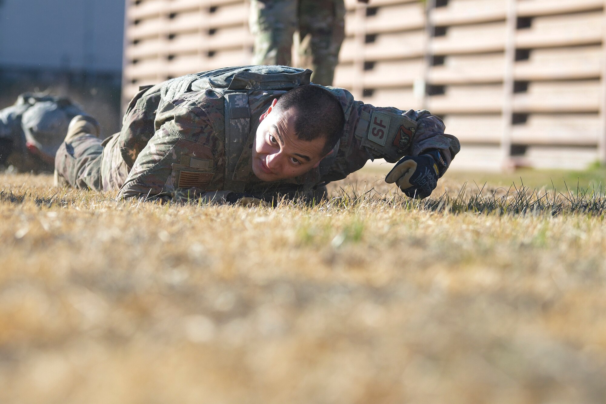 A 51st Security Forces Squadron defender low crawls during a physical training challenge as part of a Combat Readiness Course, Dec. 12, 2019, at Osan Air Base, Republic of Korea. The course challenges Osan’s newest defenders on their readiness and skills to defend the base. (U.S. Air Force photo by Staff Sgt. Greg Nash)