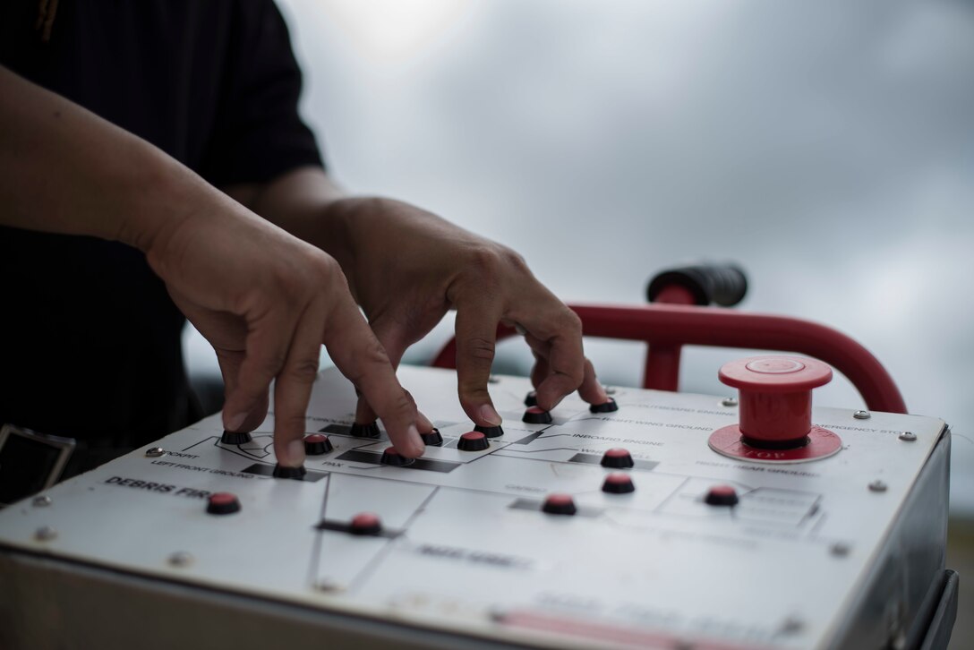 Crispin Pacificar, assistant chief of the 36th Civil Engineer Squadron, Andersen Air Force Base, Guam controls the master board to a live fire training burn January 8, 2020, at AAFB.