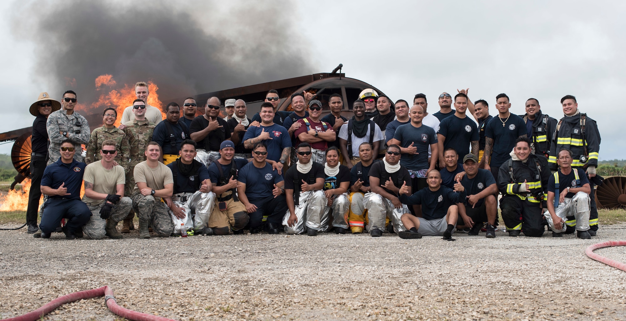 28 firefighters from Yap, Palau, Chuuk, Saipan, Rota, Guam Airport and the 36th Civil Engineer Squadron as well as some emergency responders get together for a group photo during a live fire training burn, January 8, 2020, at Andersen Air Force Base, Guam.