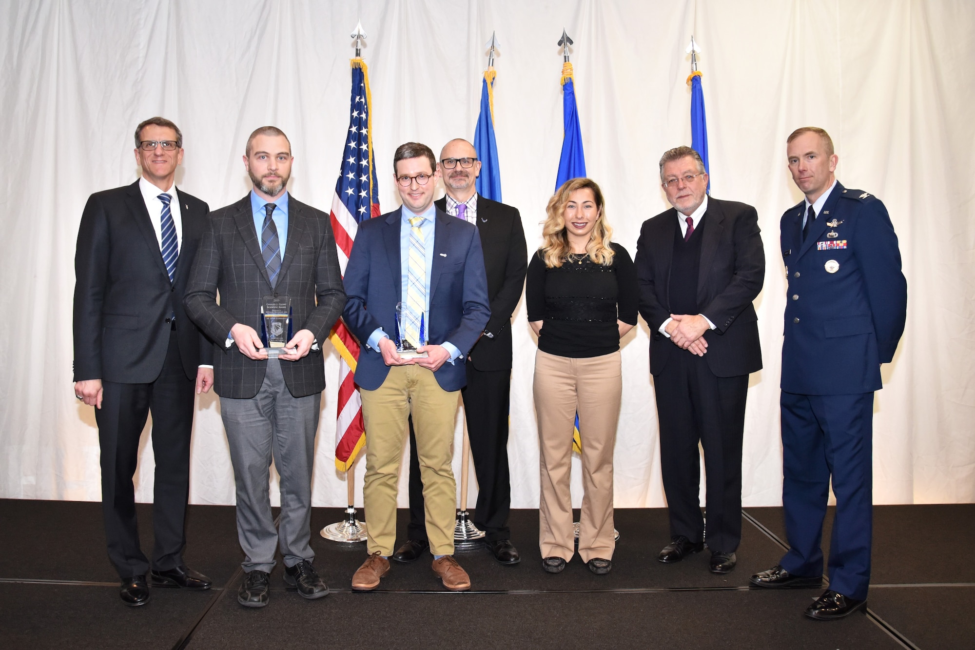 The Materials and Manufacturing Directorate’s most prestigious award at the 67th annual awards luncheon is the Charles J. Cleary Scientific Award. The winner is The Metallic Materials and Processes Research Team. Shown left to right are: Timothy Sakulich, Materials and Manufacturing Directorate Director, team members:  Dr. Edwin Schwalbach and Dr. Sean Donegan, along with Dr. Tim Bunning, Materials and Manufacturing Directorate Chief Scientist, Cara Cleary, Michael Cleary and Col. Michael Warner, Materials and Manufacturing Directorate Deputy Director. (U.S. Air Force photo/Spencer Deer)