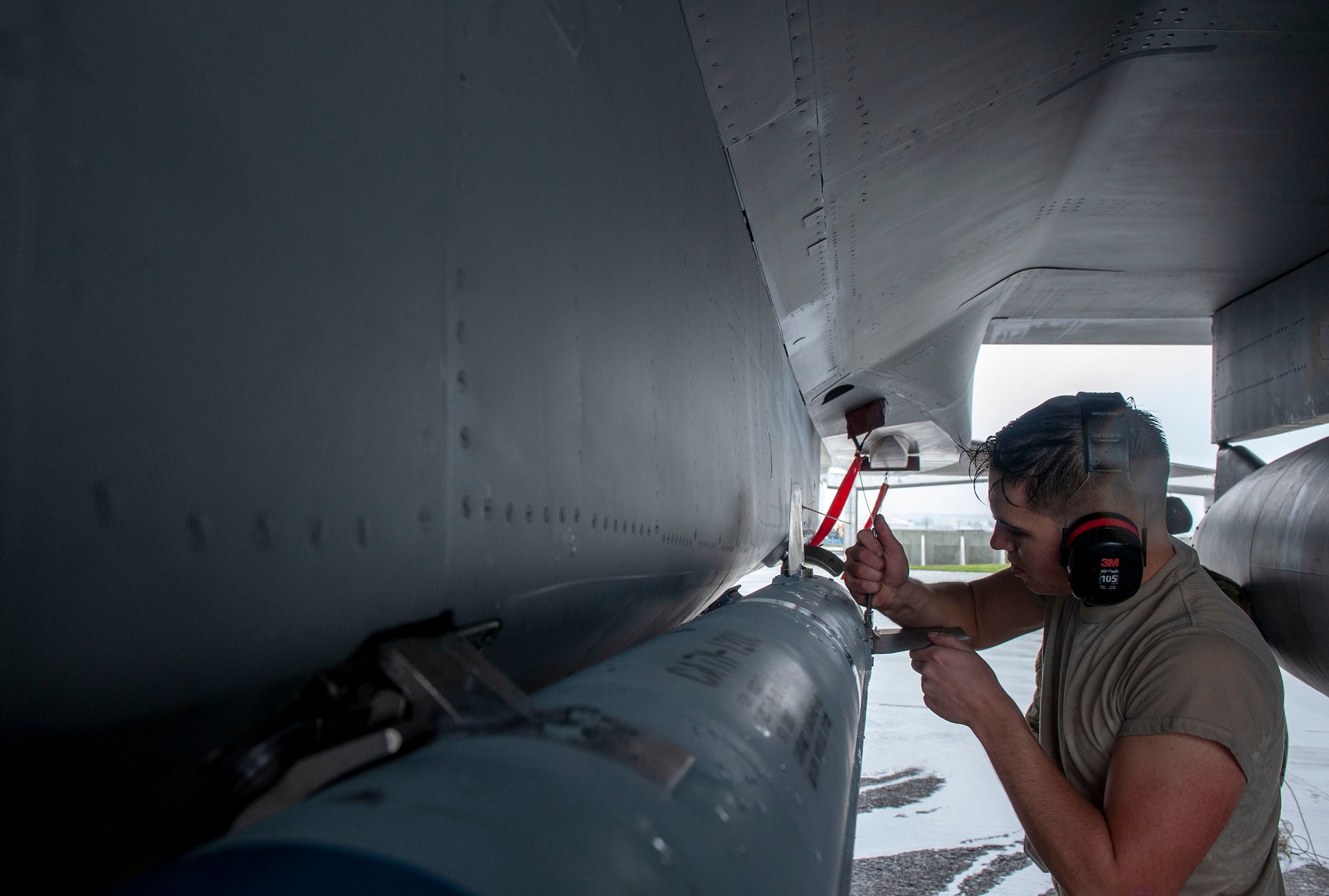 U.S. Air Force Airman 1st Class Jeffrey Abbey, 67th Aircraft Maintenance Unit load crew member, attaches a blade of an AIM-120 advanced medium-range air-to-air missile during the annual weapons load competition at Kadena Air Base, Japan, Jan. 17, 2020. Each team must load the munition onto an F-15C Eagle aircraft with speed and precision. (U.S. Air Force photo by Naoto Anazawa)