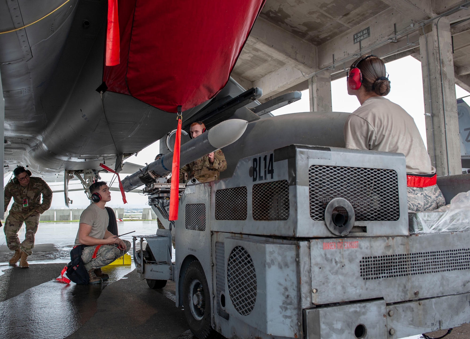 U.S. Air Force load crew members from the 67th Aircraft Maintenance Unit work together during the annual weapons load competition at Kadena Air Base, Japan, Jan. 17, 2020. During the competition, the 67th and 44th AMUs competed to see who is the best 2019 weapons load crew team within the 18th Aircraft Maintenance Squadron. (U.S. Air Force photo by Naoto Anazawa)