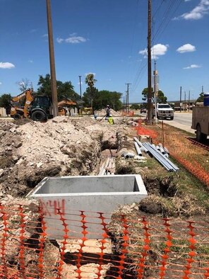 Construction is performed in front of the aerospace physiology building at Laughlin Air Force Base, Texas. The base, along with several Department of Defense installations, is currently undergoing a new utility privatization contract, which aims to modernize failing power grids. (Photo courtesy of the Rio Grande Electric Co-op)