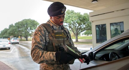 Airman 1st Class Deshaunte London from the 902nd Security Forces Squadron scans an ID card on Joint Base San Antonio-Randolph.