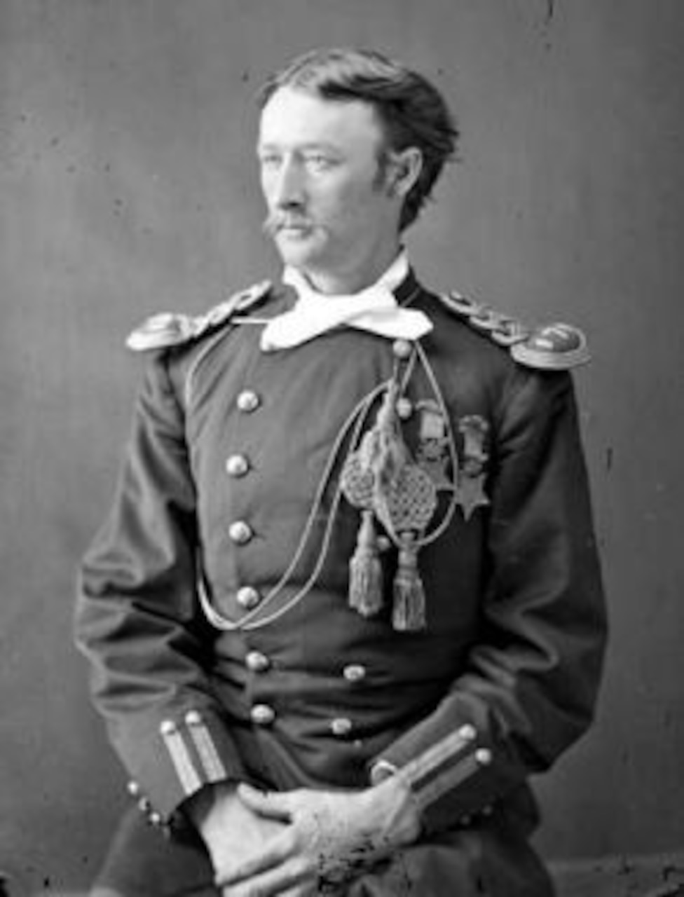 A soldier wearing a dress uniform and two Medals of Honor poses for a photo.