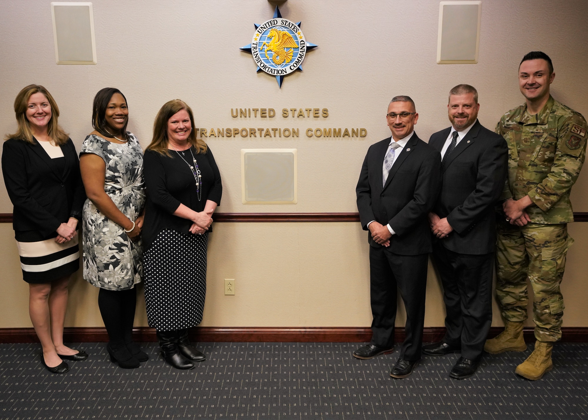 USTRANSCOM’s Protocol staff pictured left to right: Liz Wszalek, Lynn Barron, Kris Byrnside, Sergio Gonzalez, Pete Wiederholt, and U.S. Air Force Senior Master Sgt. Jerid Stephenson.