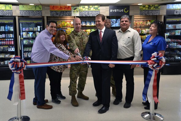 AAFES Edwards AFB General Manger John Wayne Anderson, Service Business Manager Vicki Sinclair, 412th Mission Support Group Commander Col. Jeffry Hollman, AFRL Rocket Prolusion Division Chief Dr. Shawn Phillips, AFRL-Det. 7 executive assistant 1st Lt. Ayodeji Asagba and Avenue C’s Mark Chavarria and Julie Hayes-Purcell, cut the ribbon to officially open the new micro-market at the AFRL-Det. 7 complex on Edwards Air Force Base, California, Jan. 17. (Air Force photo courtesy of John Wayne Anderson)