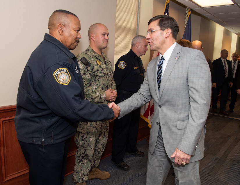 Two men shake hands.