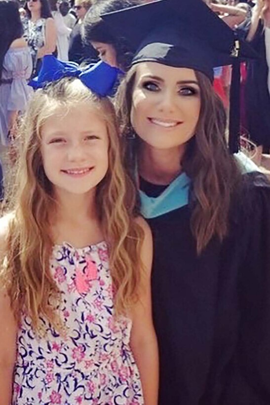 Photo of Johnson and daughter at her graduation.