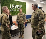 Lt. Gen. Timothy Haugh (left) Sixteenth Air Force/Air Forces Cyber Commander, accompanied by Command Chief Master Sgt. Summer Leifer (center), visit Col. Abel Carreiro (right), Air Force Life Cycle Management Center, to take a first-hand look at LevelUp Code Works, the U.S. Air Force's arm that aims to deliver rapidly deployable software to support Air Force and Department of Defense missions located in downtown San Antonio. The partnership with the Air Force Life Cycle Management Center enables develop, secure, deploy, and operate applications technology across the full range of Sixteenth Air Force missions.