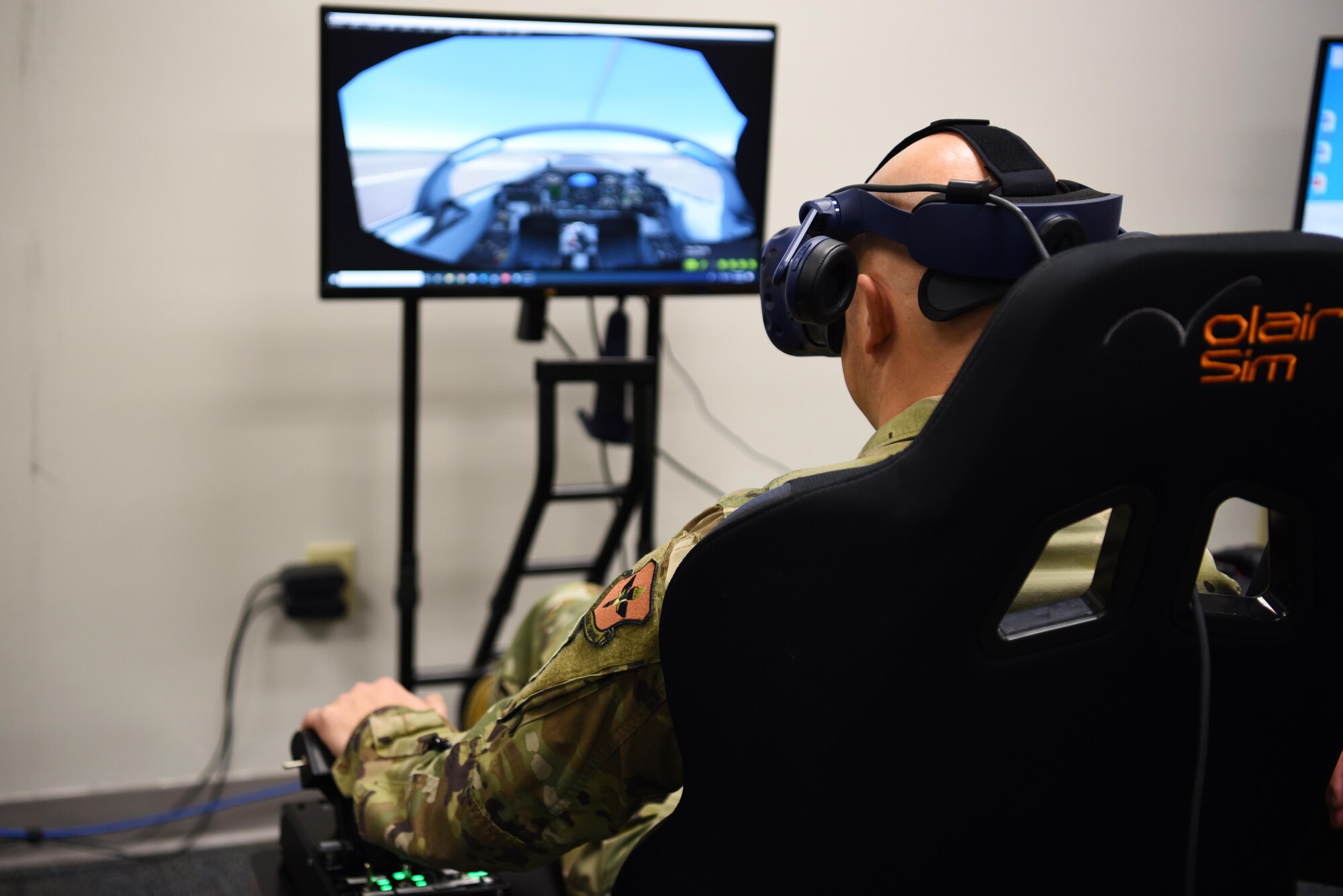 Chief Master Sgt. Trevor James, 14th Flying Training Wing command chief, operates a T-6 Texan II virtual reality simulator, Jan. 16, 2020, on Columbus Air Force Base, Miss. The virtual reality flight simulations help student pilots learn and improve on their existing skills through simulated flight exercises including taking off, landing, and flight patterns. (U.S. Air Force photo by Airman 1st Class Jake Jacobsen)