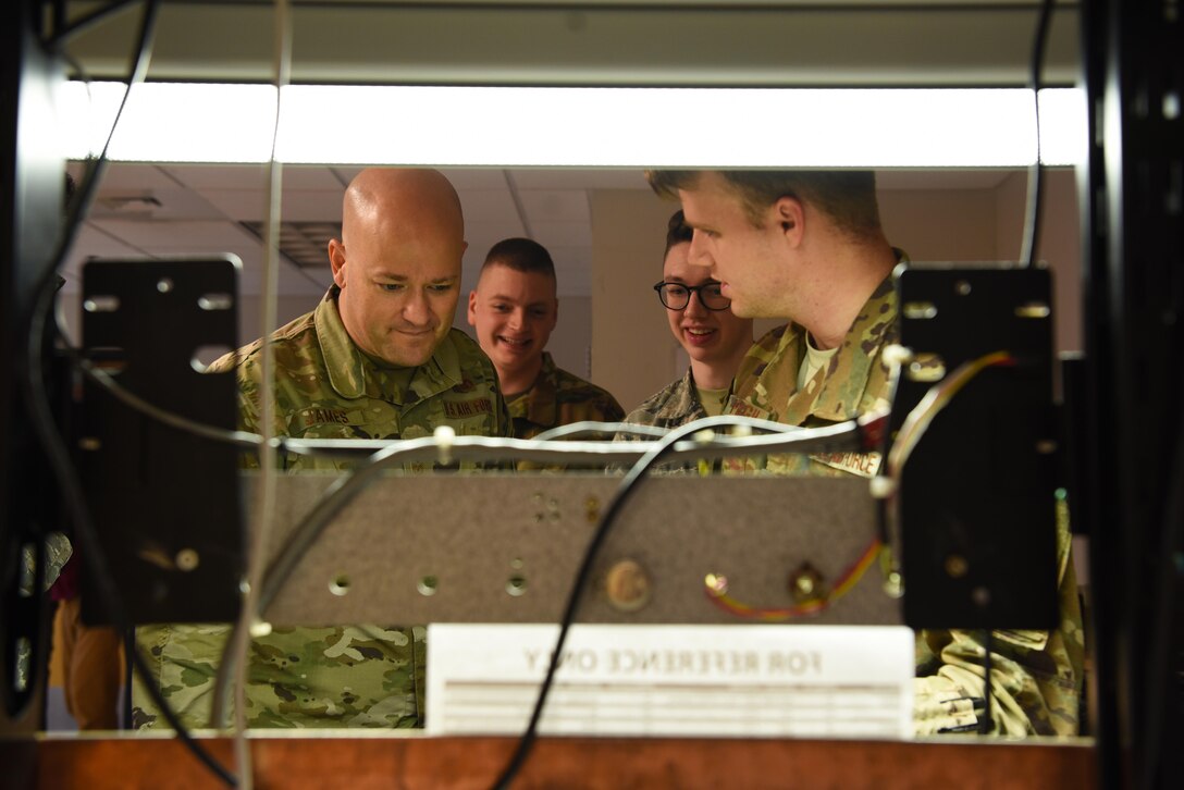 Chief Master Sgt. Trevor James, 14th Flying Training Wing command chief, examines the work bench of Radar, Airfield and Weather Systems Airmen, Jan. 16, 2020, on Columbus Air Force Base, Miss. The RAWS unit supports base and regional radar equipment, operates ground-to-air radios and weather systems that support Air Traffic Control, the National Weather Service and command and control across the wing. (U.S. Air Force photo by Airman 1st Class Jake Jacobsen)