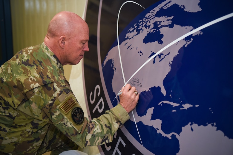 General John Raymond, U.S. Space Force chief of space operations, signs the United States Space Command sign inside of the Perimeter Acquisition Radar building Jan. 10, 2020, on Cavalier Air Force Station, North Dakota. Raymond toured inside the PAR building, where he learned first-hand how operations work inside the facility and listened to Airmen’s suggestions. (U.S. Air Force photo by Senior Airman Melody Howley)
