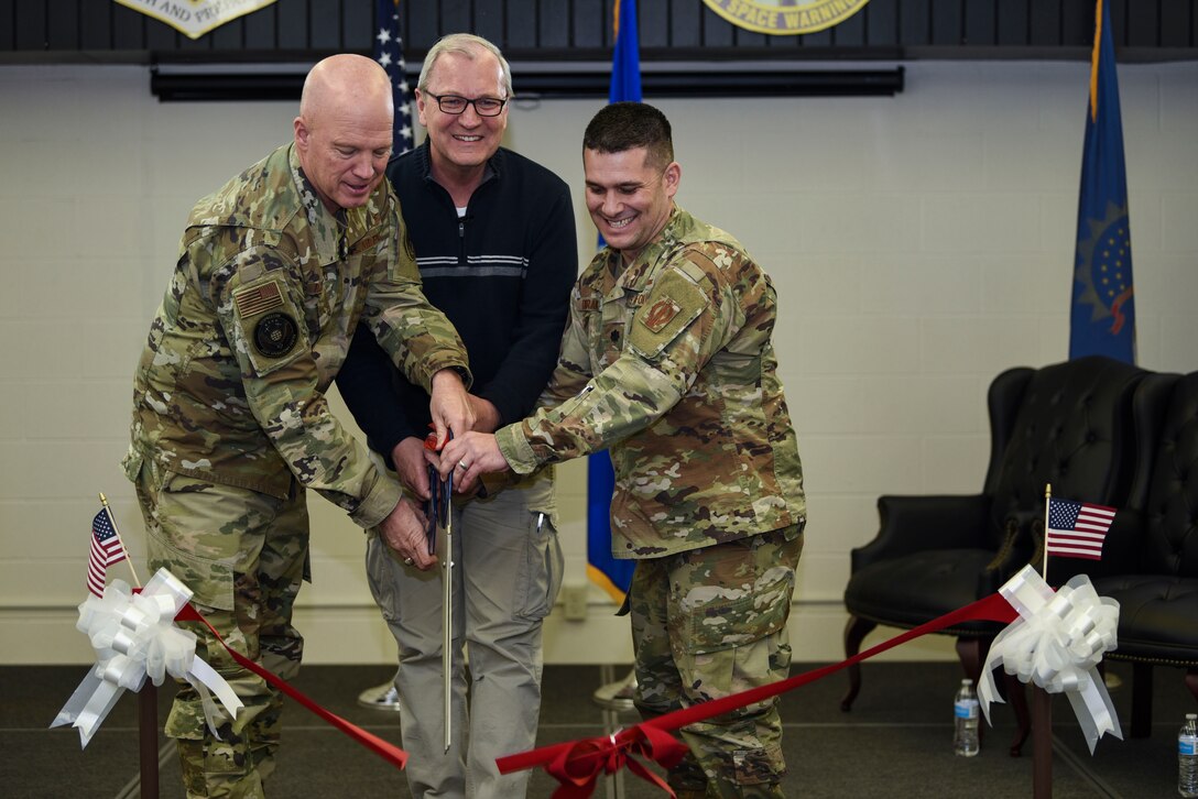 General John Raymond, U.S. Space Force chief of space operations (left), the Honorable Kevin Cramer, U.S. North Dakota senator (middle), and Lieutenant Colonel Ryan Durand, 10th Space Warning Squadron commander (right), cut a ribbon during a ceremony for the opening of the improved 10th SWS Sensitive Compartmented Information Facility Jan. 10, 2020, on Cavalier Air Force Station, North Dakota. The SCIF allows crewmembers to access timely intelligence on space and missile threat systems and adversary capabilities. (U.S. Air Force photo by Senior Airman Melody Howley)