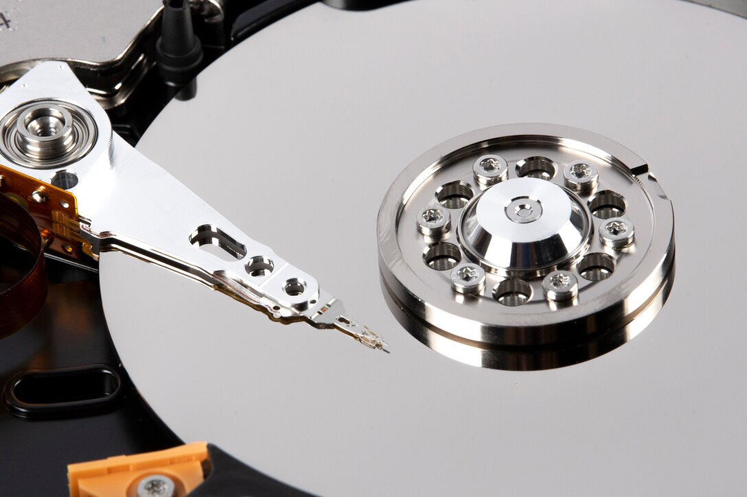 The heads of a hard drive rest over its platters.