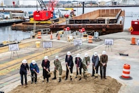 Participants in Norfolk Naval Shipyard’s Dry Dock 4 renovation groundbreaking Jan. 23 include, from left to right: Drew Quiroz, President, Asturian-Consigli JV; Stephanie Douglas, NAVSEA Director of Industrial Operations (SEA 04); John Rowe, Mayor, City of Portsmouth; Capt. Kai Torkelson, Commander, Norfolk Naval Shipyard; James Geurts, Assistant Secretary of the Navy (Research, Development and Acquisition); Congressman Robert “Bobby” Scott, 3rd District of Virginia; Cmdr. William Butler, NAVFAC Public Works Officer, Norfolk Naval Shipyard; Robert Fogel, Project Superintendent, Industrial Facilities and Equipment, Norfolk Naval Shipyard; and Stan Magann, Vice President, W.F. Magann Corporation.