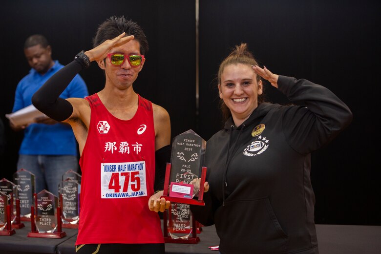 Dai Shinzato, a member of the local Okinawan community, receives congratulations for being the first to finish the Kinser Half-Marathon Jan. 12, 2020 at Camp Kinser, Okinawa, Japan.