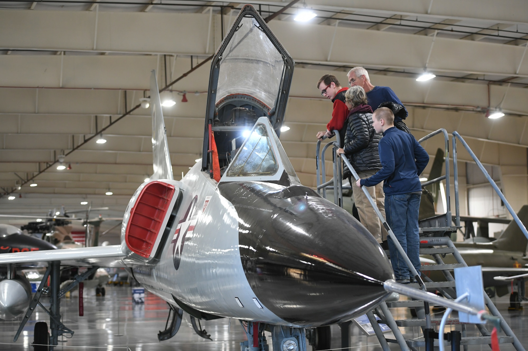 Visitors look into the cockpit of the Hill Aerospace Museum’s Convair F-106 Dec. 20, 2019, at Hill Air Force Base, Utah. The museum recently celebrated its 5 millionth visitor in November 2019. (U.S. Air Force photo by Cynthia Griggs)