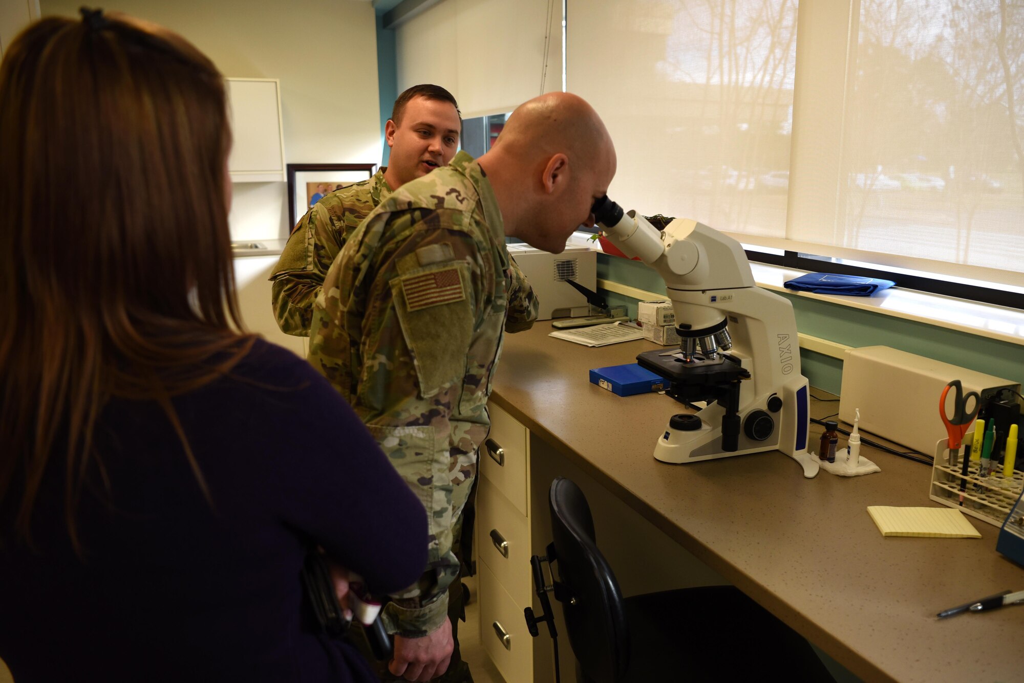 Chief Master Sgt. Trevor James, 14th Flying Training Wing command chief, looks through a binocular microscope in the laboratory department of the 14th Medical Group, Jan. 17, 2020, on Columbus Air Force Base, Miss. Binocular microscopes are optical microscopes with two eyepieces to ease viewing, increase depth perception and cut down eye strain. (U.S. Air Force photo by Airman 1st Class Jake Jacobsen)