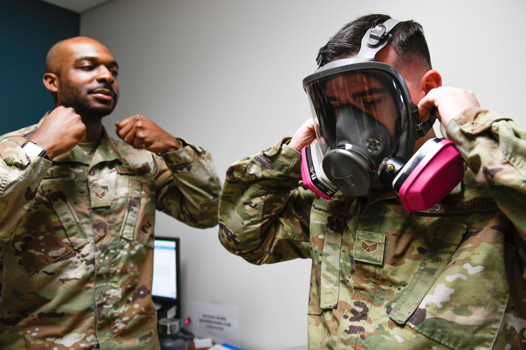 U.S. Air Force Senior Airman Gregory Rackley, 56th Occupational Medicine Readiness Squadron bioenvironmental engineering technician, instructs Senior Airman Joseph Bowden, 62nd Aircraft Maintenance Unit crew chief, on the procedure to tighten a gas mask during a fit test at Luke Air Force Base, Arizona, Jan. 14, 2020. The technicians administer fit tests for individuals who are deploying, and individuals perform various movements while wearing the gas mask to test how well it fits to their face. Bioenvironmental engineering’s mission is to provide reliable health risk expertise to optimize human performance and prevent adverse health effects of Airmen. (U.S. Air Force photo by Airman 1st Class Brooke Moeder)