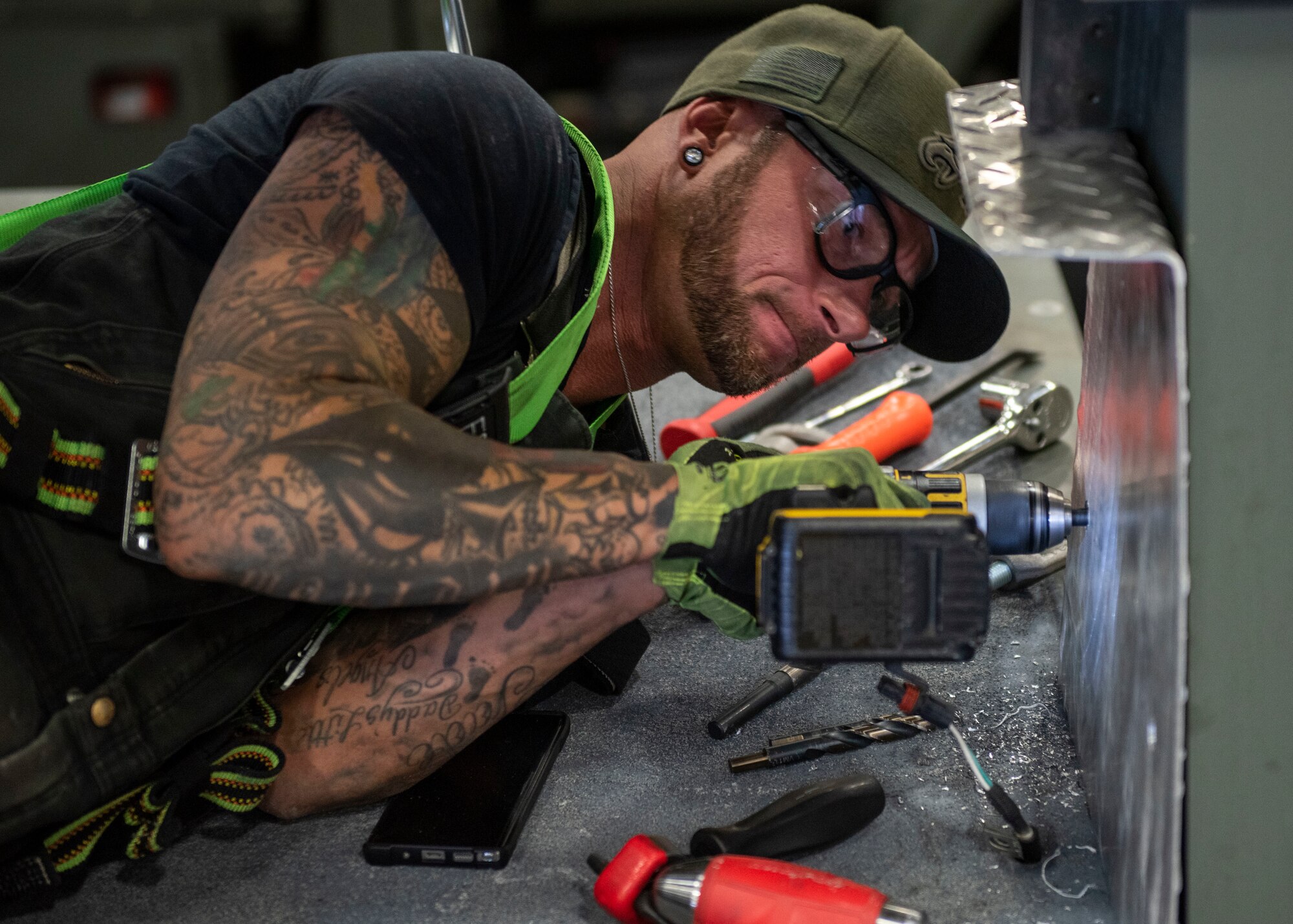 Jessie Mauldin, 673d Logistics Readiness Squadron heavy mobile equipment mechanic, drills a hole for an eyelet on top of a deicing truck to tether a fall-protection safety harness at Joint Base Elmendorf-Richardson, Alaska, Jan. 22, 2019. The modification involves strategically attaching four eyelets to the top of each truck so mechanics can attach a mobile safety harness. Mauldin has taken steps to push his innovation to all heavy mobile equipment maintenance shops Air Force-wide.