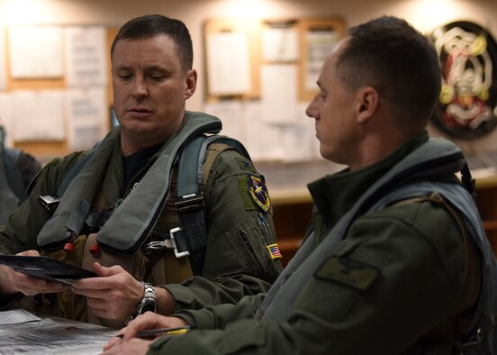 U.S. Air Force Col. Jack Fischer, 50th Space Wing vice commander, and Col. Tad Clark, 8th Fighter Wing commander, prepare for a briefing prior to transiting to their respective F-16 Fighting Falcon aircraft at Kunsan Air Base, Republic of Korea, Jan. 22, 2020. Fischer and Clark graduated from the U.S. Air Force academy together in Colorado Springs, Col. in 1996. (U.S. Air Force photo by Staff Sgt. Anthony Hetlage)