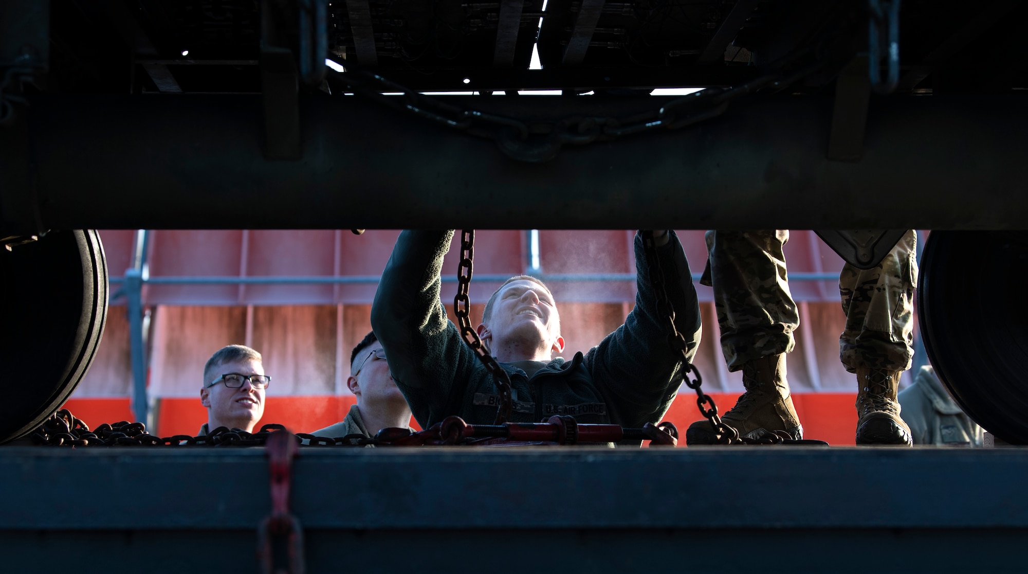 U.S. Air Force Senior Airman Austin Collier, ground transportation trainer, left, Airman 1st Class Andrew Mach, ground transportation support operator, and Airman 1st Class Jacob Biggs, ground transportation operator, center, all from the 52nd Logistics Readiness Squadron, prepare to unload a trailer on the flightline at Ramstein Air Base, Germany, Jan. 22, 2020. Airmen from the 52nd LRS notified units of cargo needed, loaded equipment, provided transportation, and refueled F-16 Fighting Falcons. The effort was in support of an Agile Combat Employment exercise, which allowed Airmen to provide combat power with varying levels of support. (U.S. Air Force photo by Airman 1st Class Valerie Seelye)