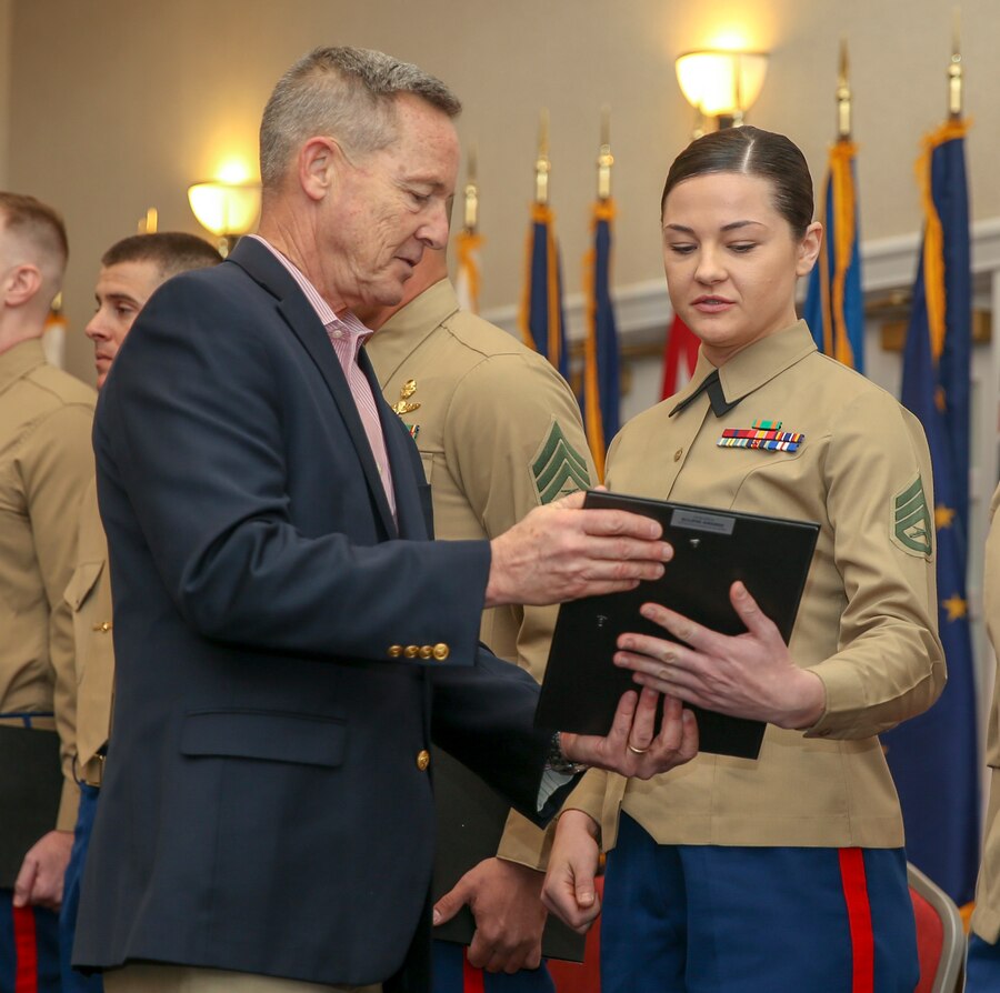 U.S. Marine Corps Ret. Lt. Gen Mark Faulkner, Chief Executive Officer of Marine Corps Association Foundation presents a gift to Staff Sgt. Alyssa M. Burke, Marine Corps security guard, American Embassy Laos, Vientiane at the Commandant of the Marine Corps’ Combined Awards Ceremony at The Clubs at Quantico aboard Marine Corps Base Quantico, Va., Jan. 22, 2020. The ceremony recognizes commands with the highest combined physical and combat fitness performance, as well as top recruiters, instructors, athletes, and career planners around the Marine Corps. (U.S. Marine Corps photos by Lance Cpl. Piper A. Ballantine)