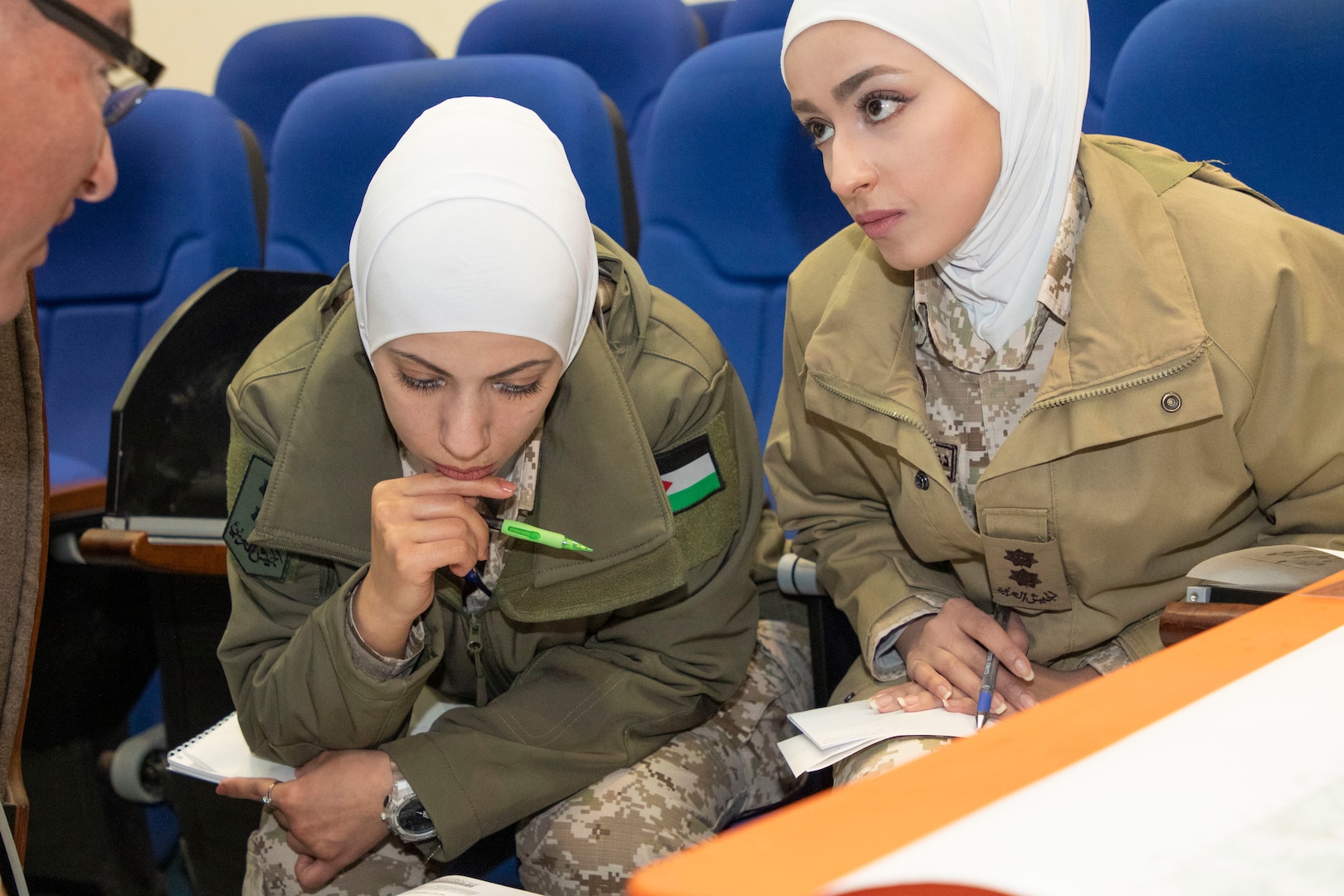 A U.S. Army Soldier, with Military Engagement Team-Jordan, 158th Maneuver Enhancement Brigade, Arizona Army National Guard, discusses map azimuths with Jordan Armed Forces-Arab Army (JAF) Quick Reaction Force Female Engagement Team Soldiers during a Map Reading Subject Matter Expert Exchange at a base outside Amman, Jordan Jan. 13, 2020. The United States is committed to the security of Jordan and to partnering closely with the JAF to meet common security challenges.