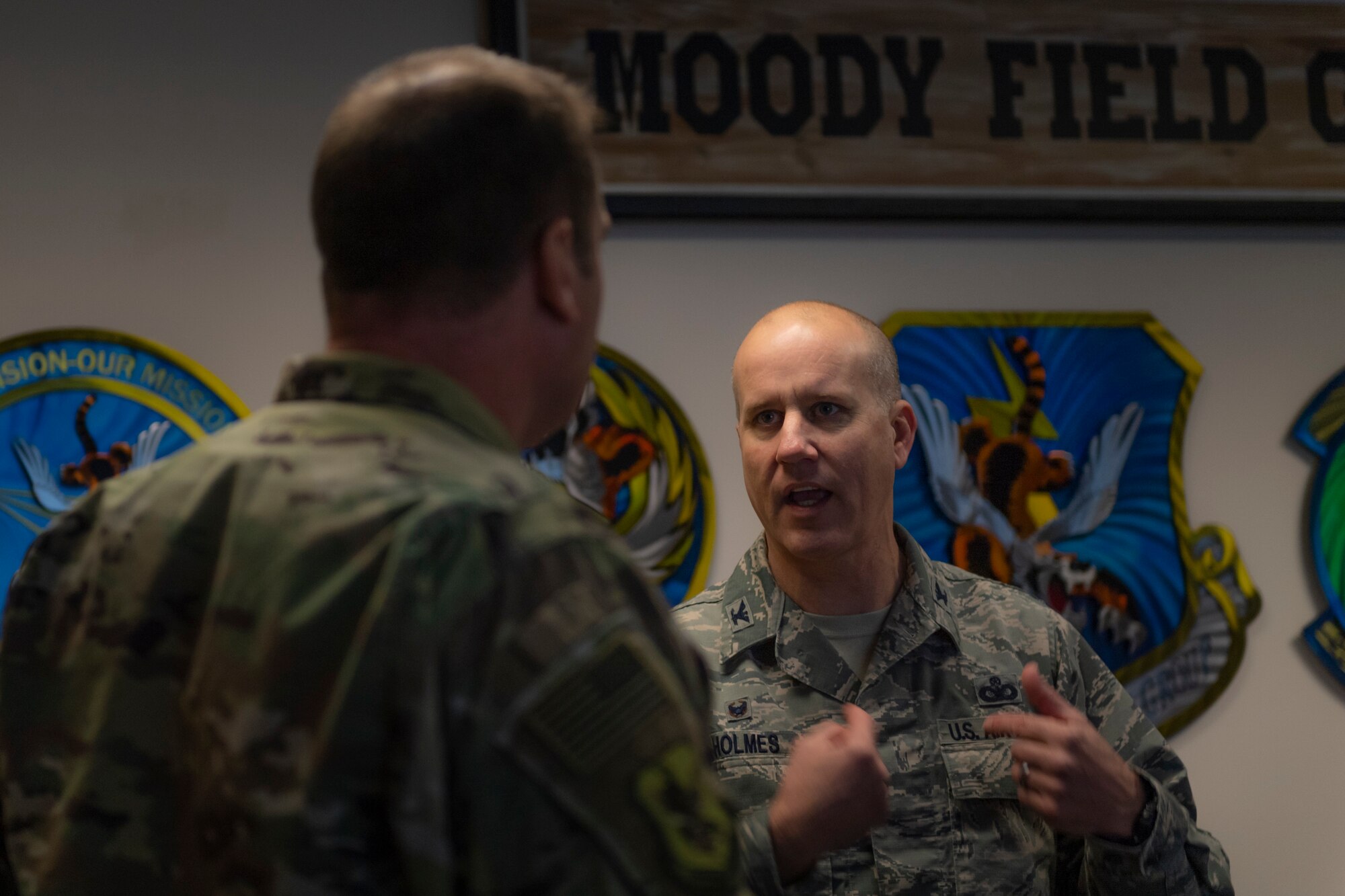 A photo of two Airmen talking