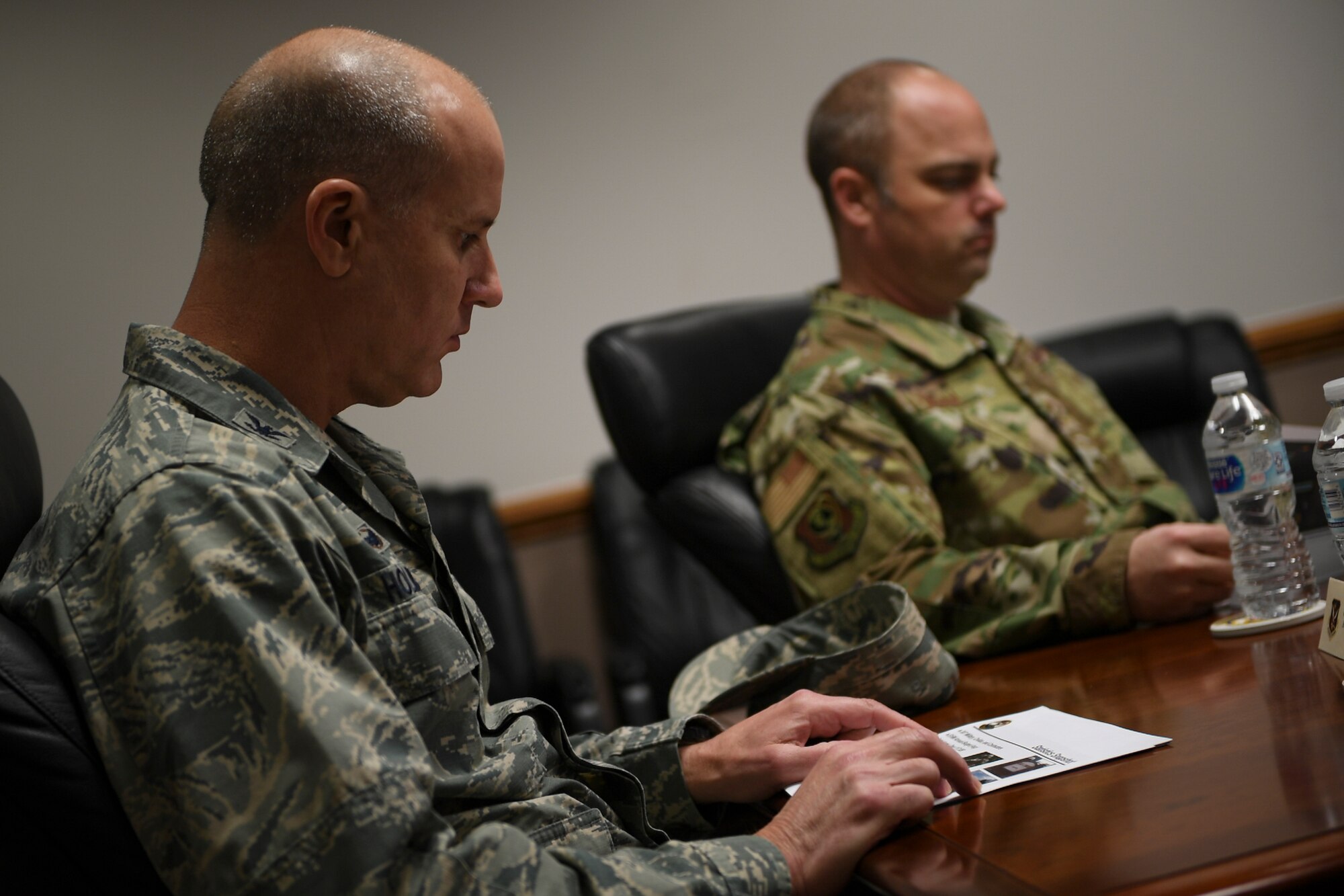 A photo of an Airman reading a mission brief