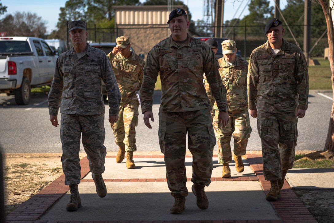 A photo of Airmen walking into a building