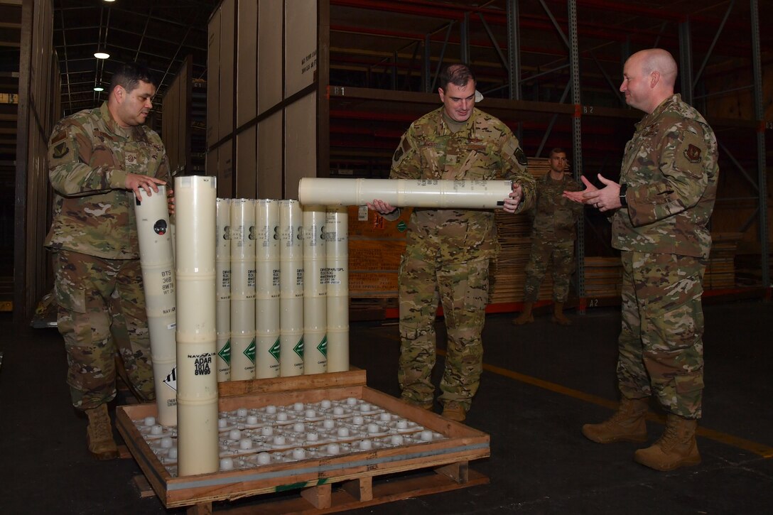 U.S. Air Force Brig. Gen. Mark R. August, 86th Airlift Wing commander, center, and U.S. Air Force Chief Master Sgt. Ernesto J. Rendon, 86th AW command chief, left, are shown sonobuoy systems by U.S. Air Force Lt. Col. Adam P. King, 65th Air Base Squadron commander, at Lajes Field, Portugal, Jan. 21, 2020.