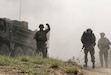 1st Lt. Ronald Wetherson, executive officer and acting commander of A Company, 103rd Engineer Battalion, 56th Stryker Brigade Combat Team, 28th Infantry Division, Pennsylvania Army National Guard, calls for infantry Soldiers to funnel through the breach just cleared by combat engineers using a Bangalore June 29 in North Macedonia as part of Decisive Strike 19. (U.S. Army National Guard photo by Staff Sgt. Zane Craig)
