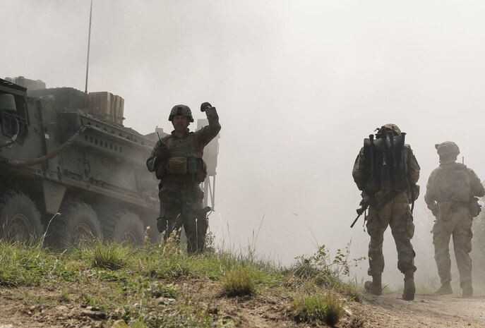 1st Lt. Ronald Wetherson, executive officer and acting commander of A Company, 103rd Engineer Battalion, 56th Stryker Brigade Combat Team, 28th Infantry Division, Pennsylvania Army National Guard, calls for infantry Soldiers to funnel through the breach just cleared by combat engineers using a Bangalore June 29 in North Macedonia as part of Decisive Strike 19. (U.S. Army National Guard photo by Staff Sgt. Zane Craig)