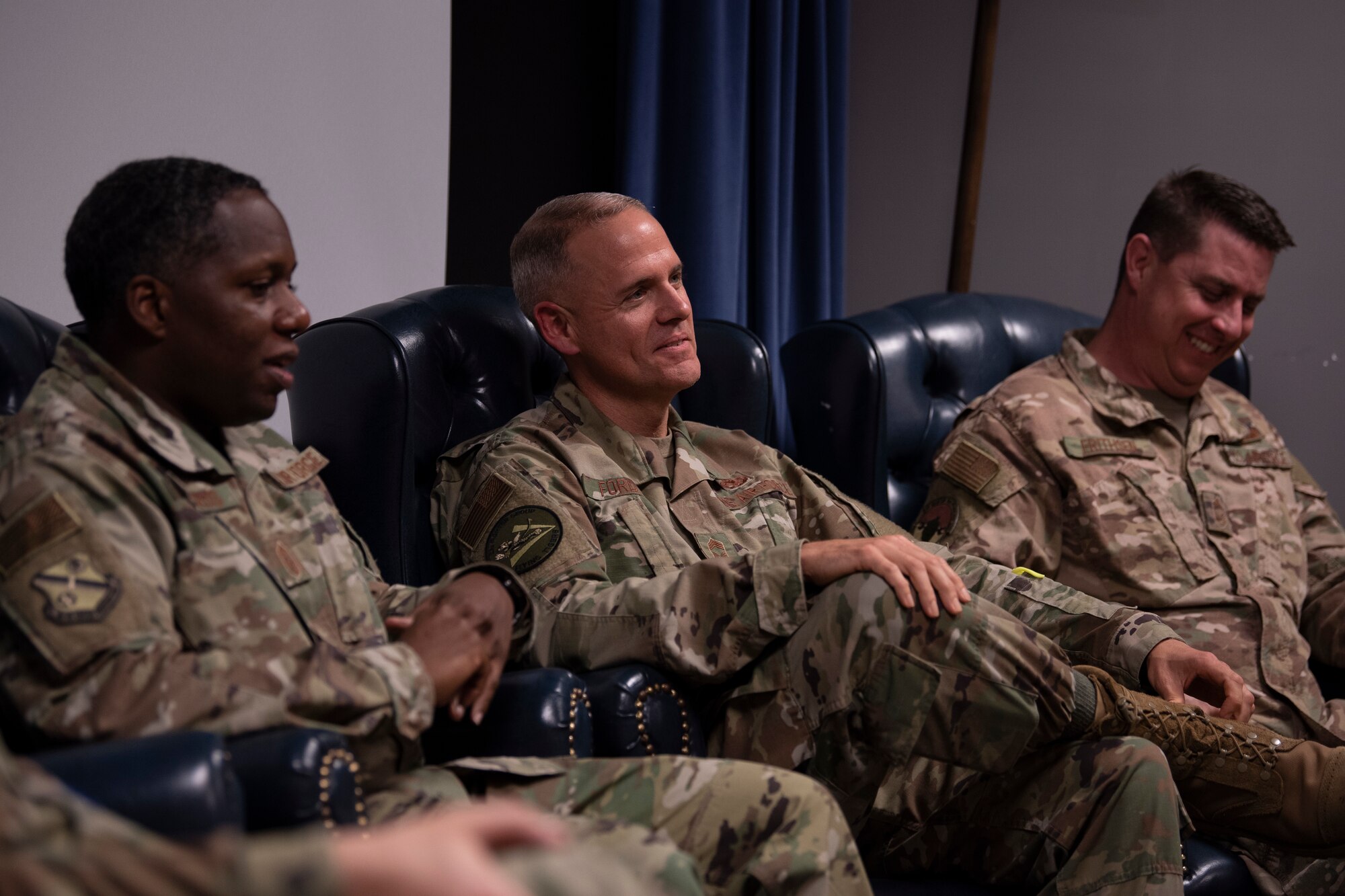 A photo of leadership sharing a laugh while answering questions during the Airman Leadership School Class 20-B’s Chief Panel.
