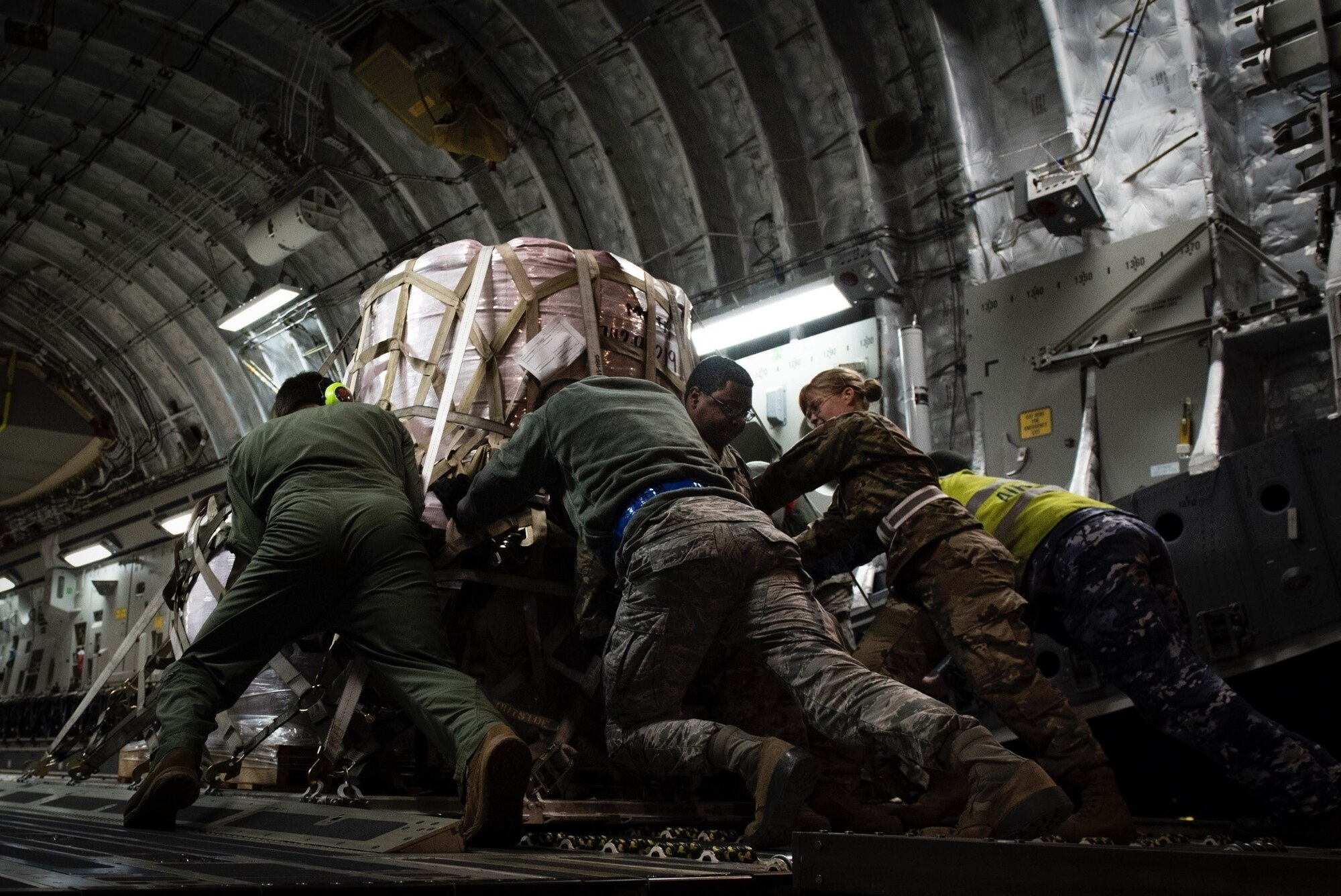 U.S. and Australian airmen worked together to loaded the aircraft with materials to aid in Australian wildfire relief