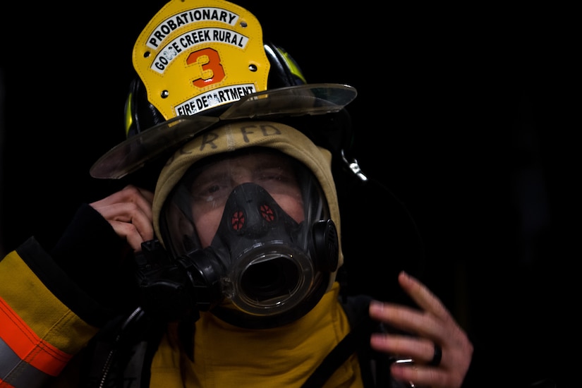 1st Lt. Joshua Heffley, 437th Maintenance Group executive officer and volunteer firefighter, straps on his firefighter helmet during weekly firehouse readiness training, at the Goose Creek Rural Fire Department, Goose Creek, S.C., Dec. 3, 2019.