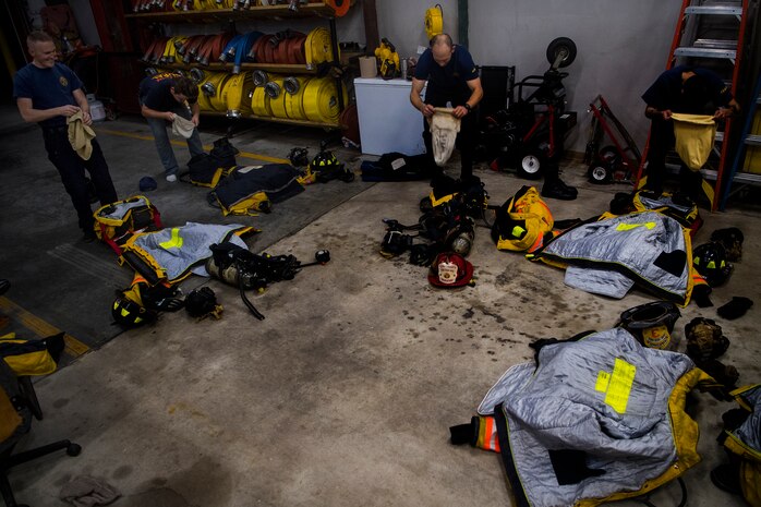 Volunteer firefighters put on their gear during weekly firehouse readiness training, at the Goose Creek Rural Fire Department, Goose Creek, S.C., Dec. 3, 2019.