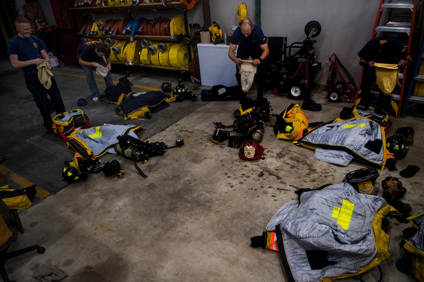 Volunteer firefighters put on their gear during weekly firehouse readiness training, at the Goose Creek Rural Fire Department, Goose Creek, S.C., Dec. 3, 2019.