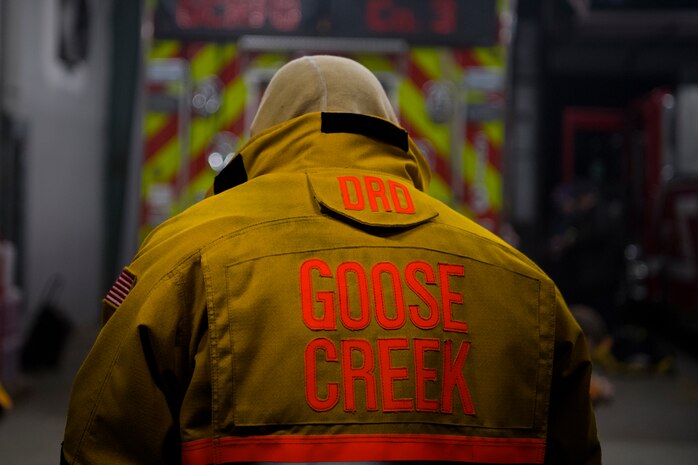 1st Lt. Joshua Heffley, 437th Maintenance Group executive officer and volunteer firefighter, puts on his firefighter coat during weekly firehouse readiness training at the Goose Creek Rural Fire Department, Goose Creek, S.C., Dec. 3, 2019.