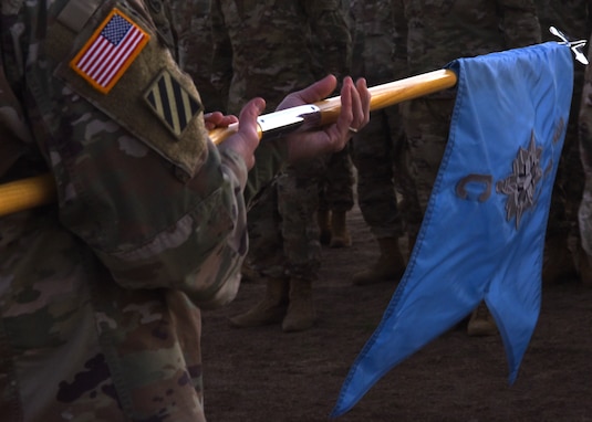 U.S. Army Lt. Col. Brian Ryan, 344th Military Intelligence Battalion commander, unrolls the Charlie Company Guidon at the Activation Ceremony and Assumption of Command on the parade field at Goodfellow Air Force Base, Texas, Jan. 24, 2019. Ryan prepared to pass the Guidon, which signifies him transferring his trust and the responsibility of the company’s enlisted members. (U.S. Air Force photo by Airman 1st Class Abbey Rieves)