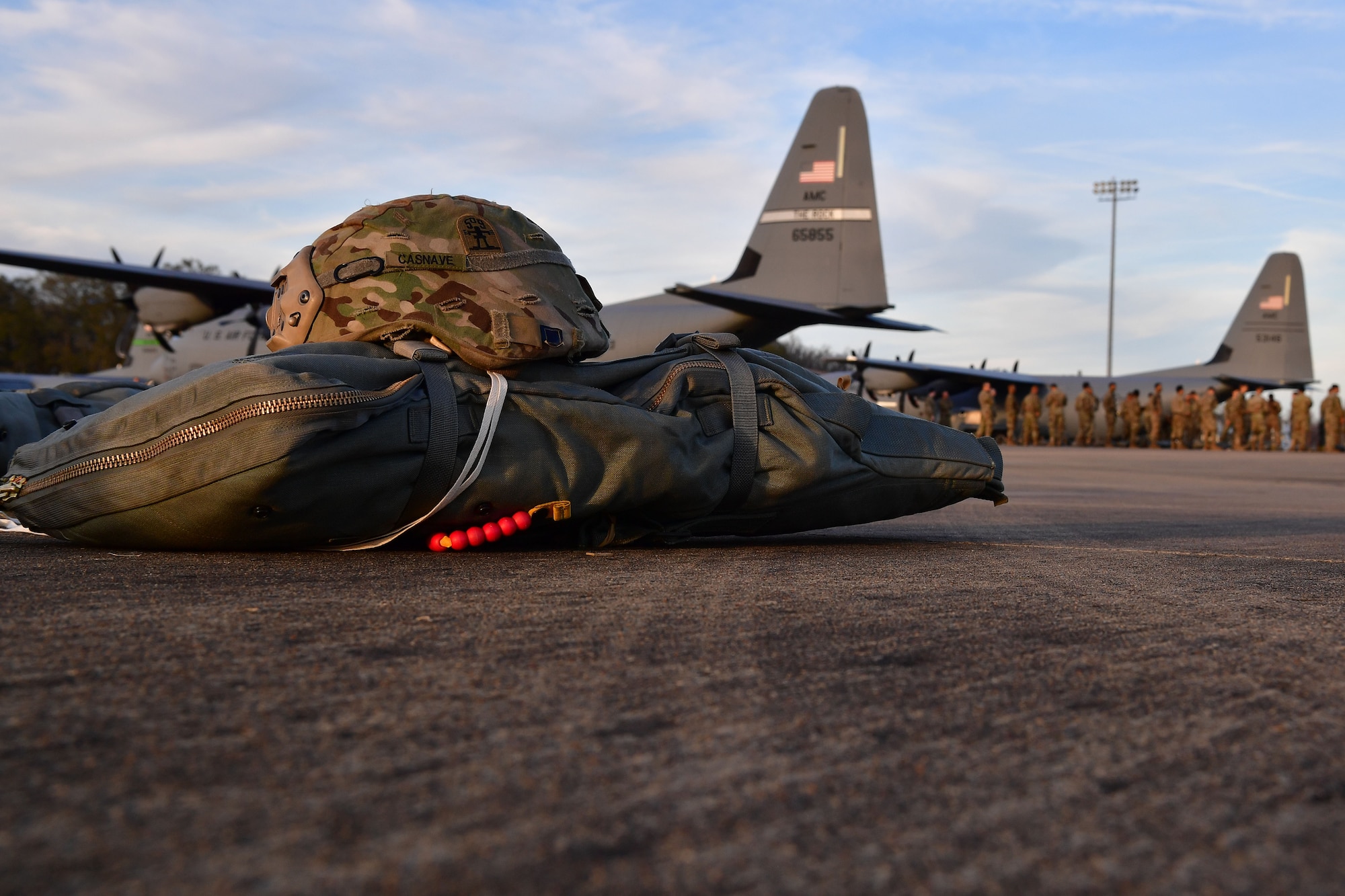 Soldiers from the 4th Brigade Combat Team (Airborne), 25th Infantry Division, at Joint Base Elmendorf-Richardson, Alaska, prepare their gear prior to boarding a C-130J Super Hercules during the joint forcible entry and airborne assault which kicked off Green Flag Little Rock 20-03.