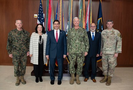 Defense Secretary Dr. Mark T. Esper poses for a photo with military personnel.
