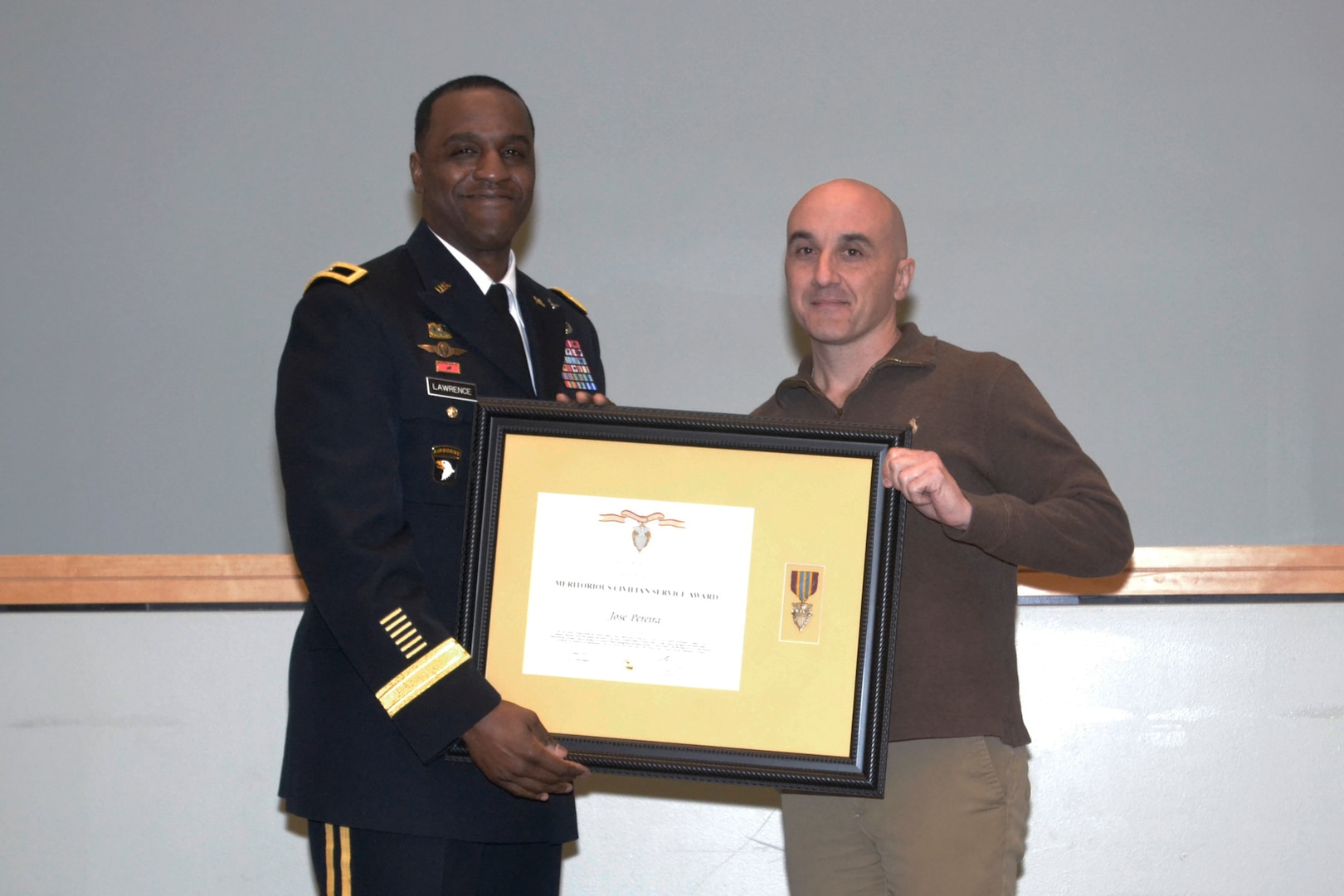 Jose Periera, DLA Troop Support Industrial Hardware Technical Quality division chief, receives the Civilian Meritorious Service award from DLA Troop Support Cmmander Army Brig. Gen. Gavin Lawrence Jan. 21, 2020 at DLA Troop Support in Philadelphia.   Periera was one of three IH employees who received the award for their work managing and assisting with the acquisition of roughly 940,000 items for more than 11,000 customers.